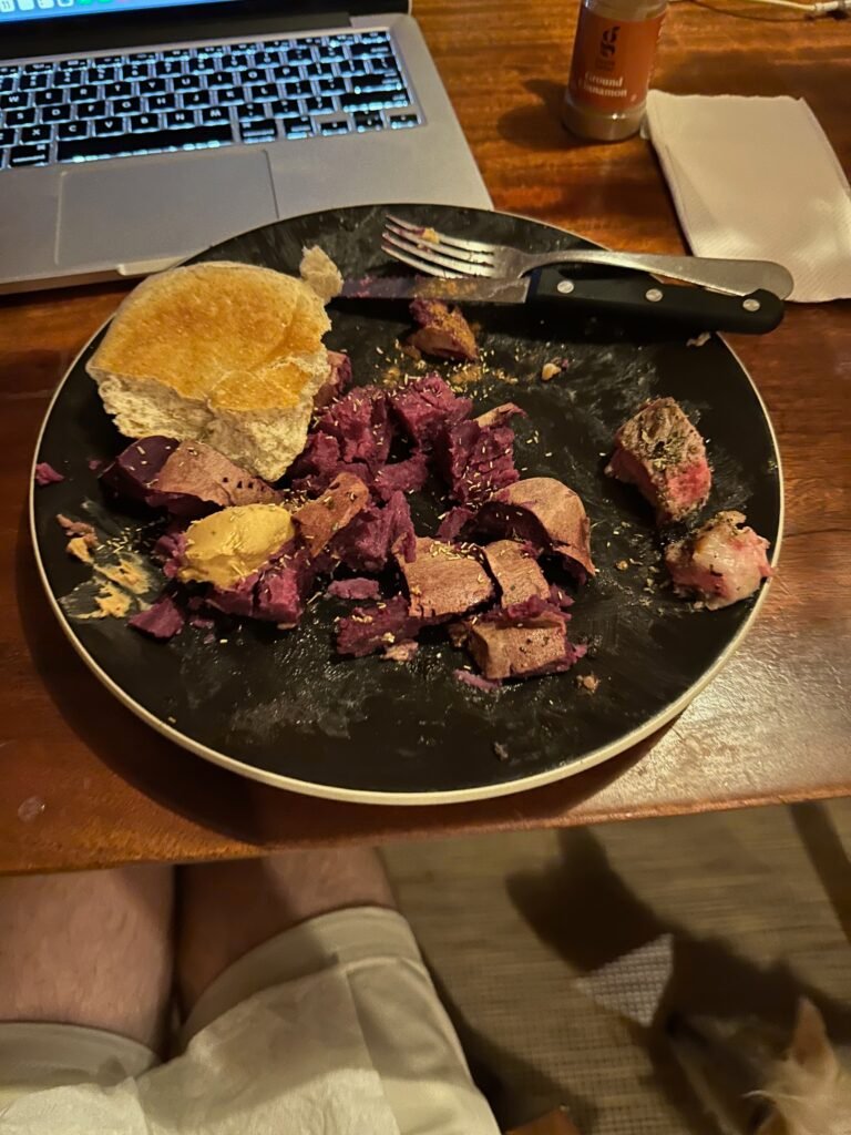 My dinner, consisting of bread, a purple sweet potato, and steak