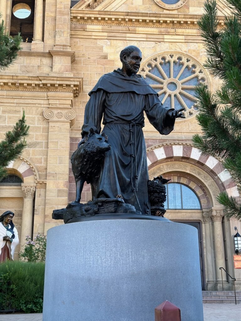 sculpture of a monk or a priest with a dog